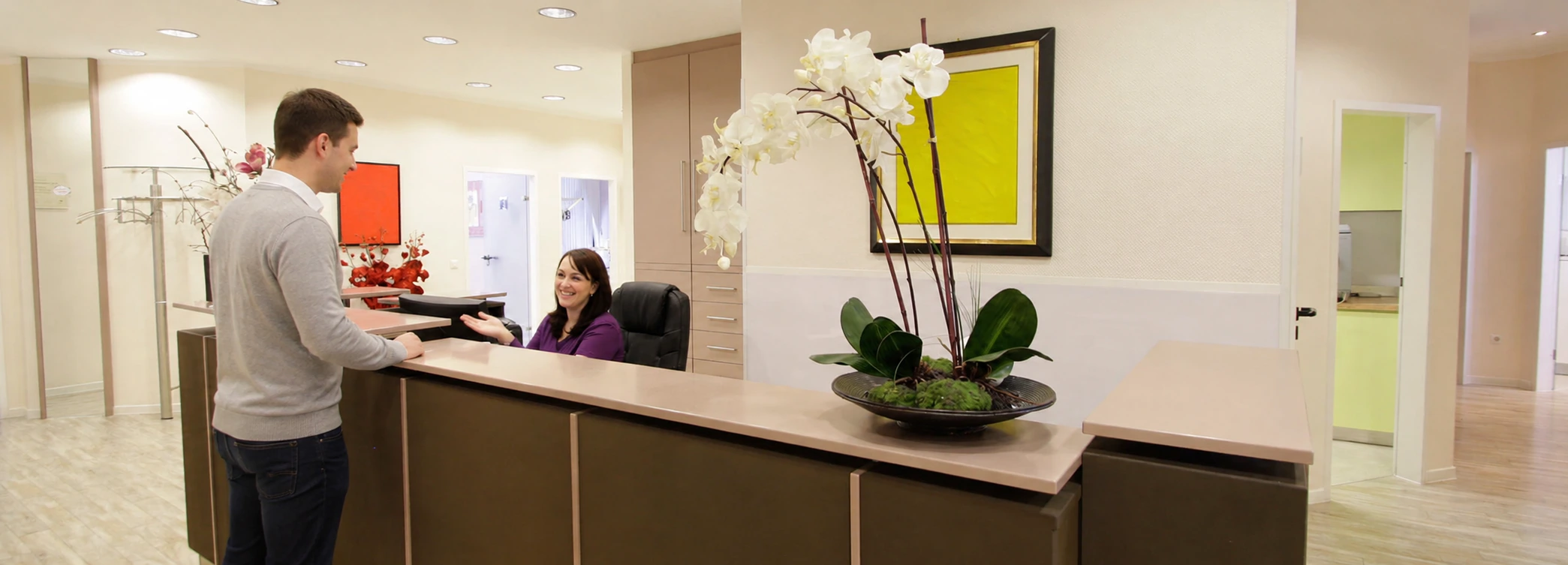 A patient being welcomed at the reception of the Rita Goutkin dental practice