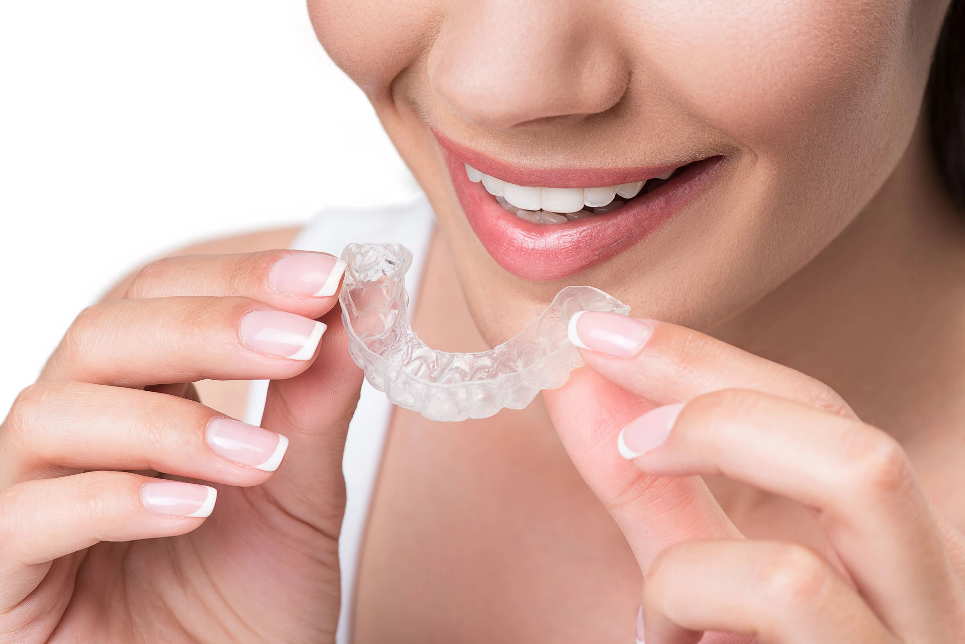 Patient inserting a transparent clear aligner at the Cologne practice